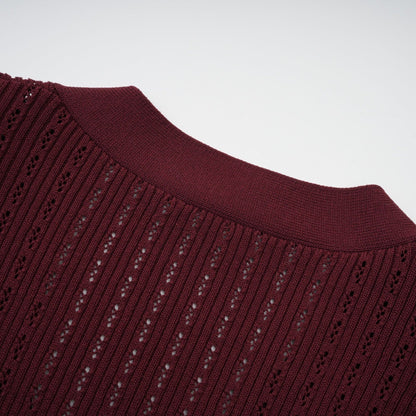 Woman wearing red knitted top with ruffles and matching skirt set