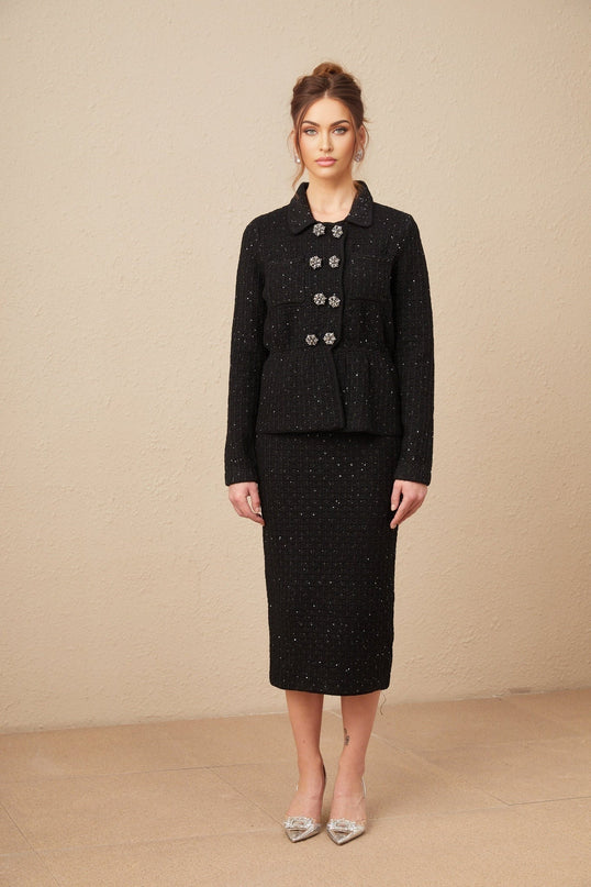 Woman wearing sequined waffle knit jacket and matching skirt set in shimmering Amina design