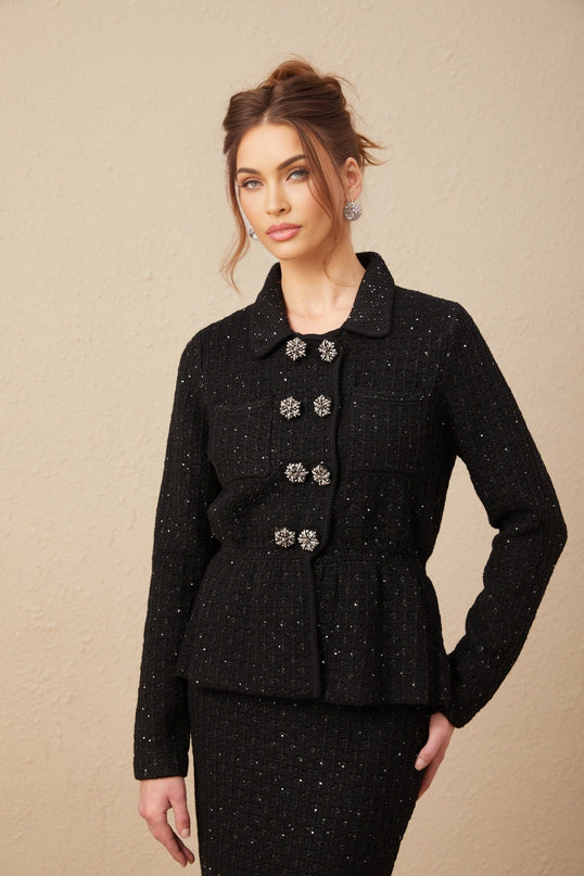 Woman wearing sequined waffleknit jacket and matching skirt set named Amina in a glamorous pose