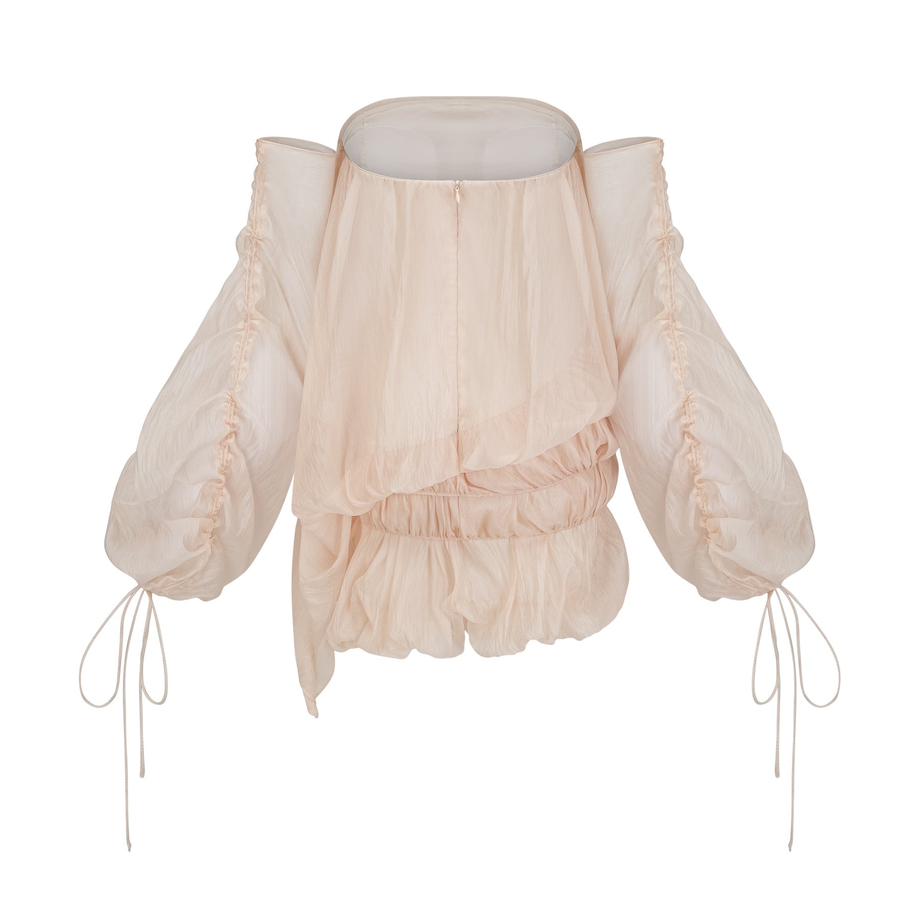Woman wearing short white layered dress with off shoulder design and ruched fabric tied at waist