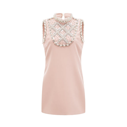 Pink dress with sleeveless design crystal and faux pearl embellishments and thigh length fastened at the rear Composed of 80% Polyester and 20% Cotton