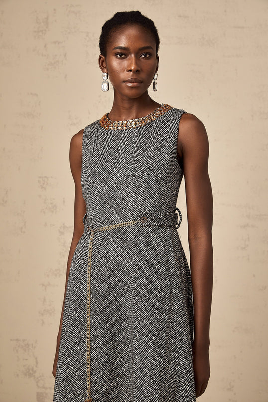 Woman wearing sleeveless grey tweed midi dress with crystal embellishments for Valentines Day occasion