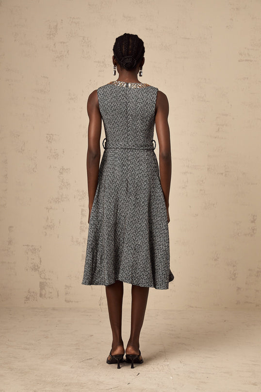 Woman wearing sleeveless grey tweed midi dress with crystal embellishments for Valentines Day occasion