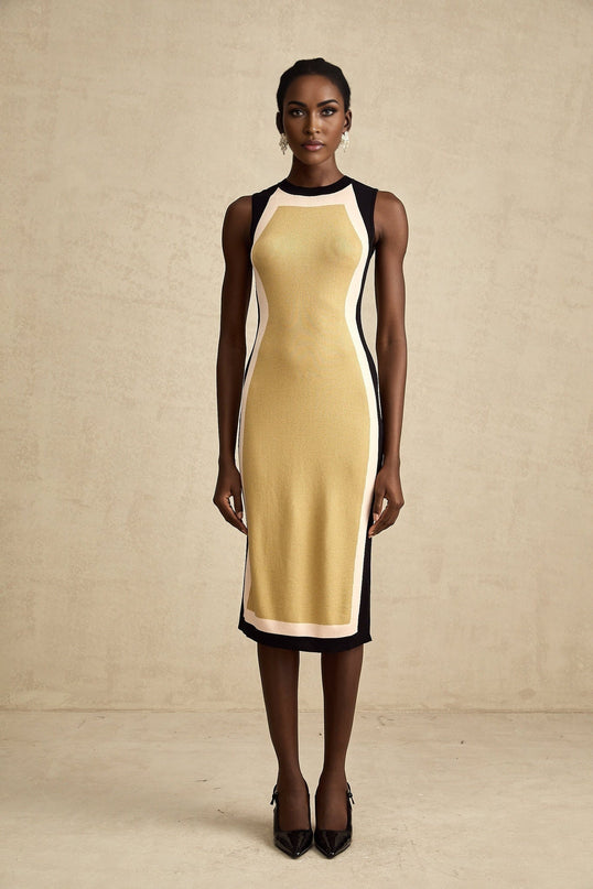 Woman wearing sleeveless knitted midi dress with contrast color details and fitted silhouette