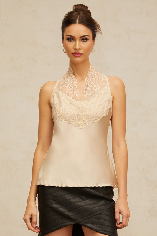 Woman wearing sleeveless satin top with floral lace panels in neutral color