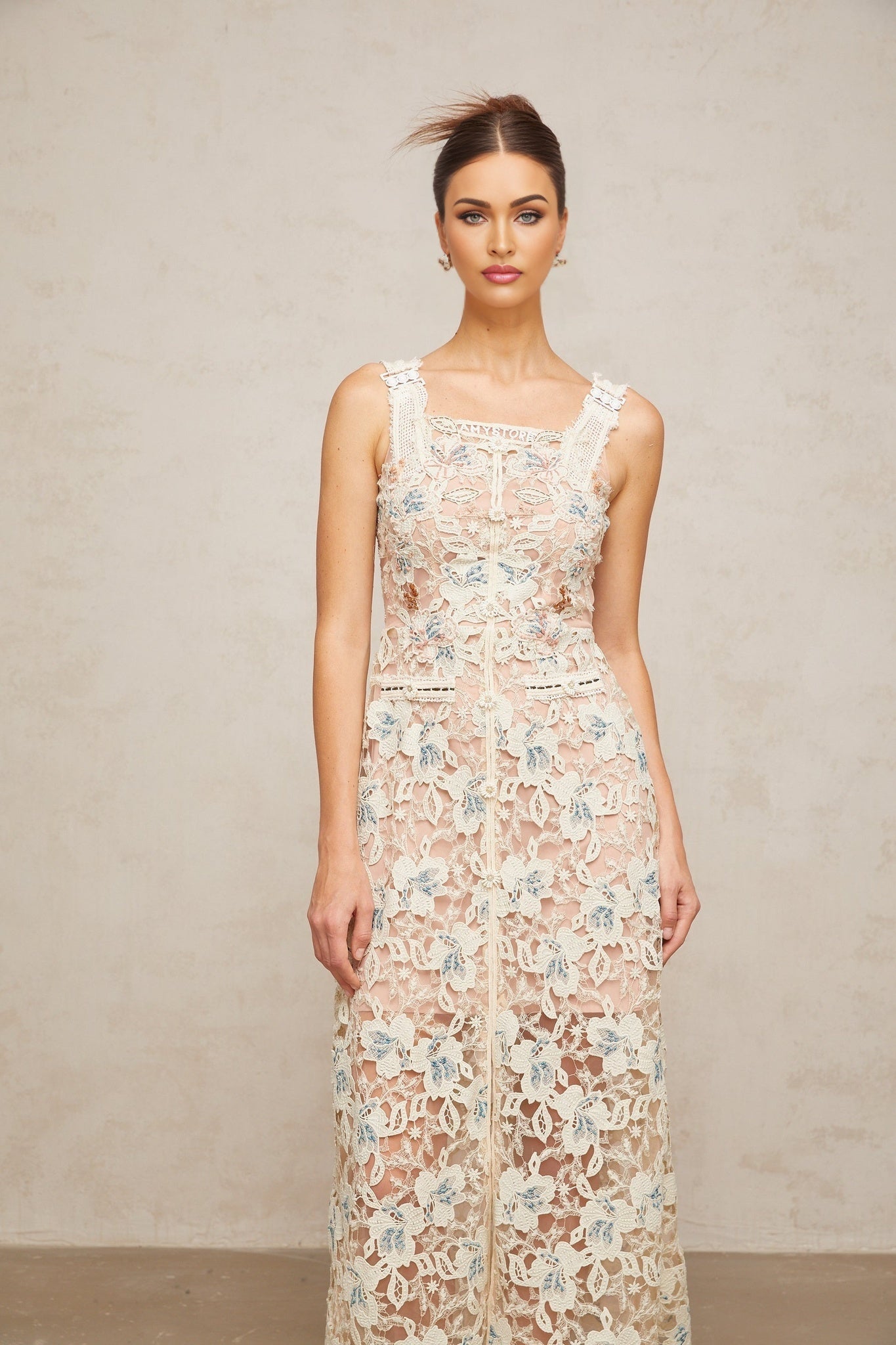 Woman wearing white Aline midi dress with floral lace pattern sleeveless design and scoop neckline