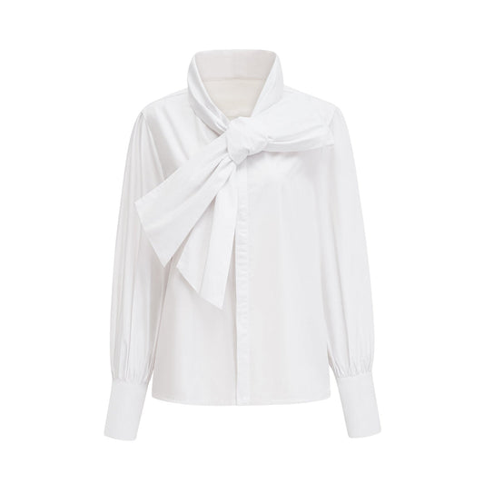 Woman wearing white cotton buttonup shirt with tie front detail and long sleeves