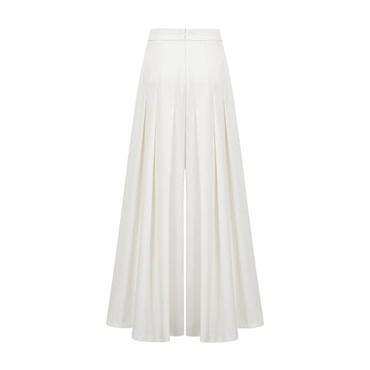 Woman wearing white creased top and matching trousers set Adele style outfit