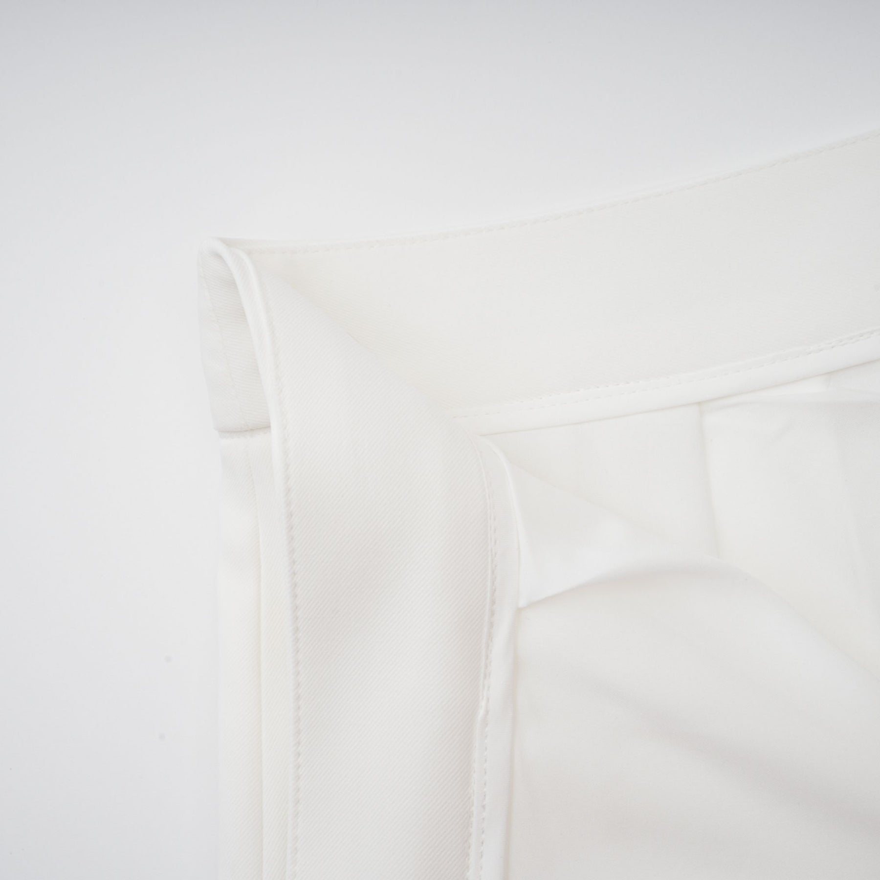 Woman wearing white creased top and matching trousers set