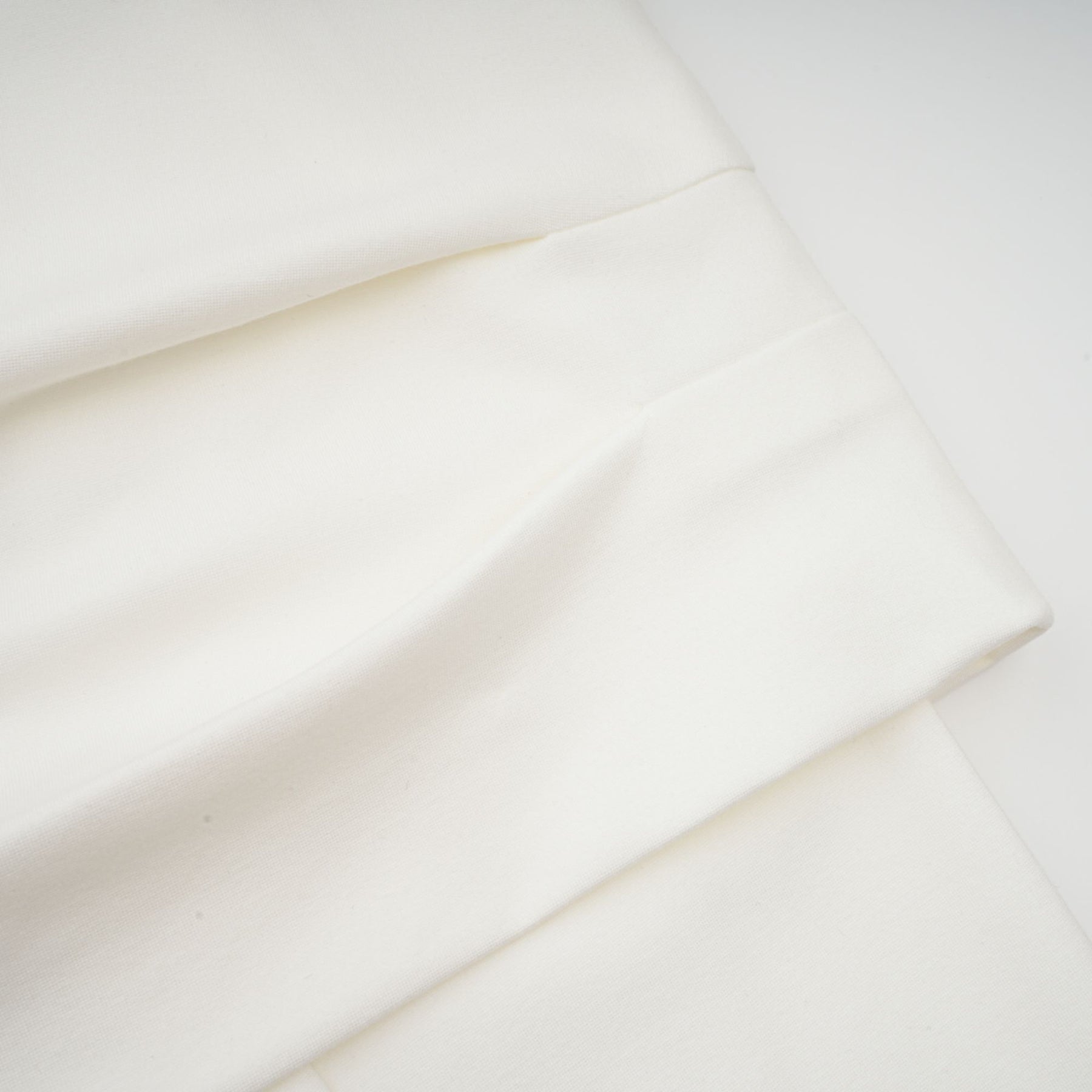 Woman wearing white cropped sleeveless top with ruched detailing