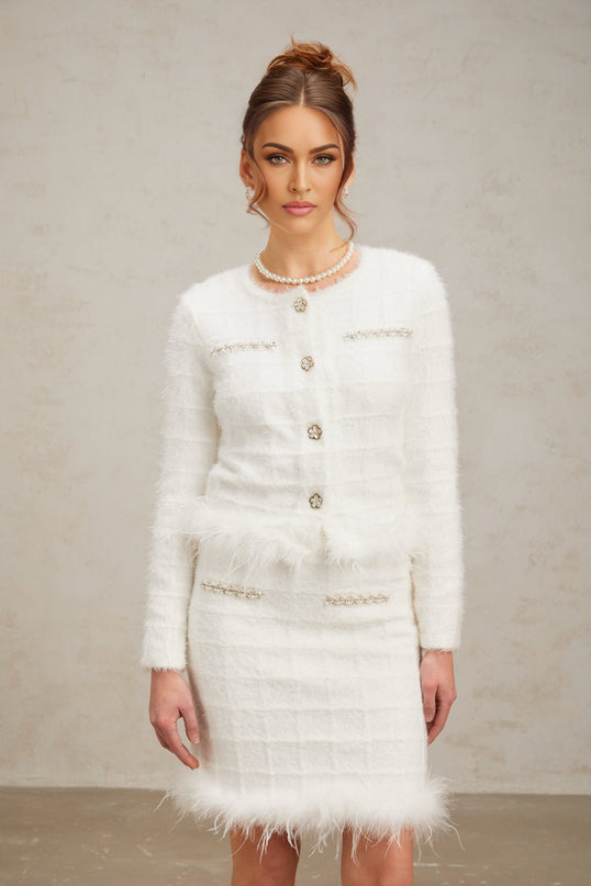 Woman wearing white feather waffle knit cardigan and matching skirt set