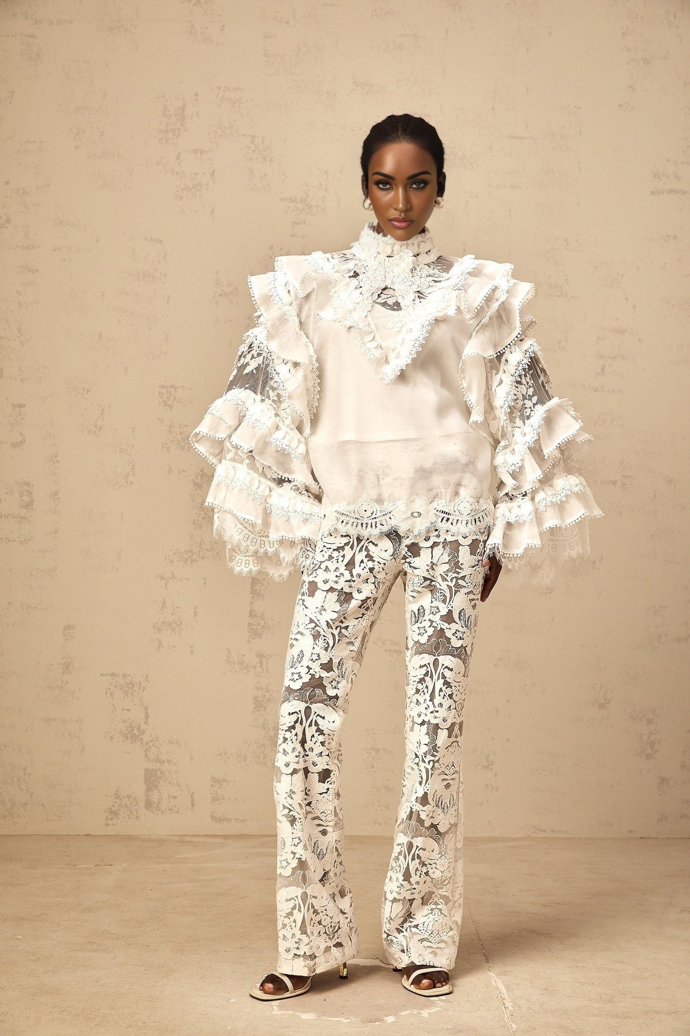 Woman wearing white lace blouse with tied front and layered design