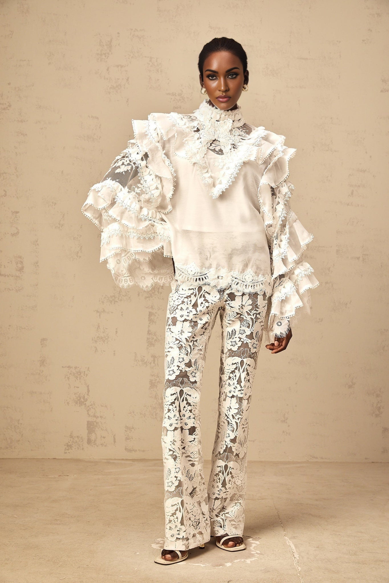 Woman wearing white layered lace blouse with tied neckline