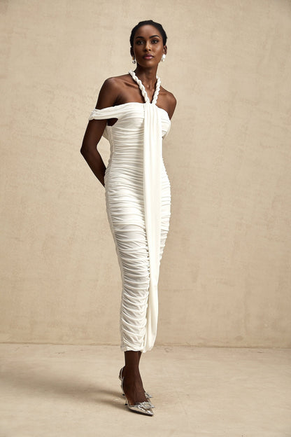 Woman wearing white midi dress with braided rope details and sleeveless design