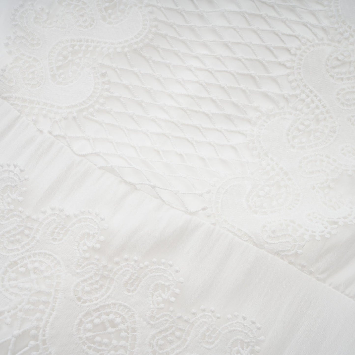 Woman wearing white midi dress with lace trim panels and belt at waist