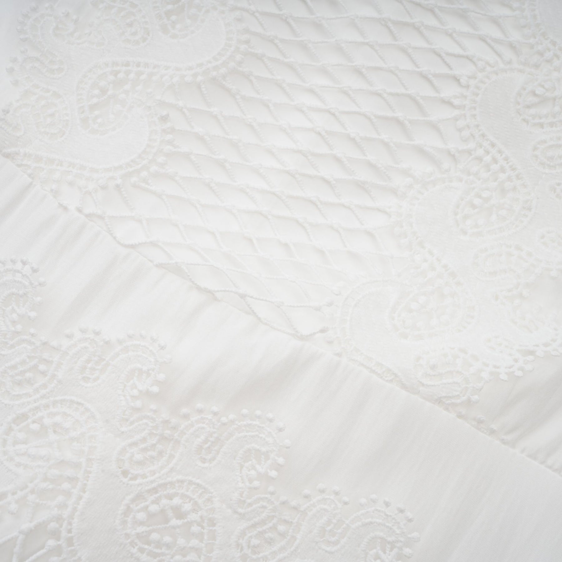 Woman wearing white midi dress with lace trim panels and belt at waist