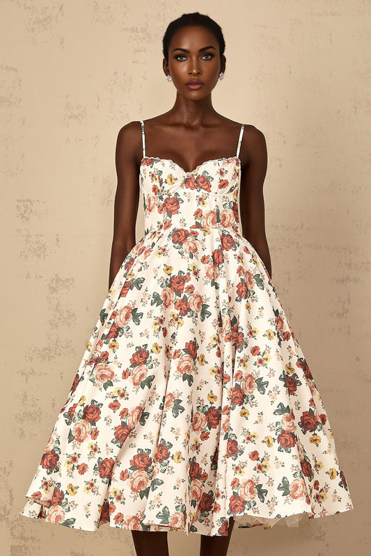 Woman wearing white midi dress with rose print pattern and flounced details