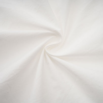Woman wearing white shirt with floral pattern and cut out details