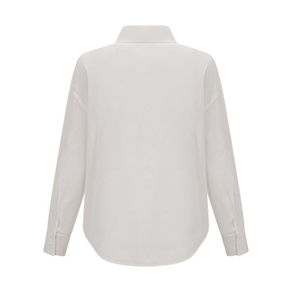 Woman wearing white shirt with floral pattern and cutout details
