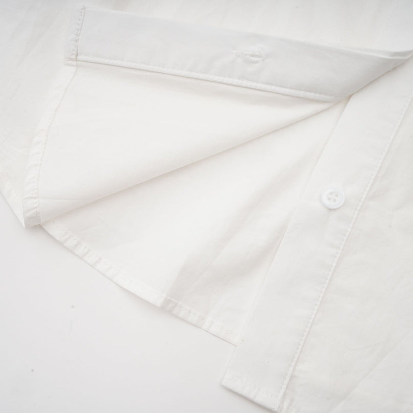 Woman wearing white shirt with floral pattern and cutout details