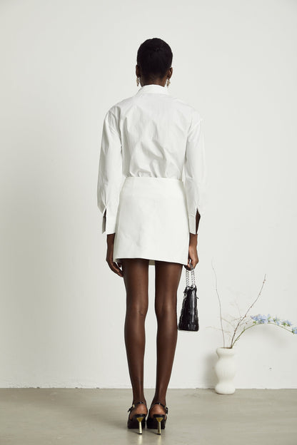 Woman wearing white shirt with floral pattern and cutout details