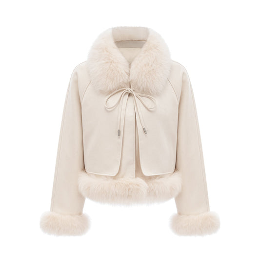 Woman wearing white suede short coat with fur trim and padded design