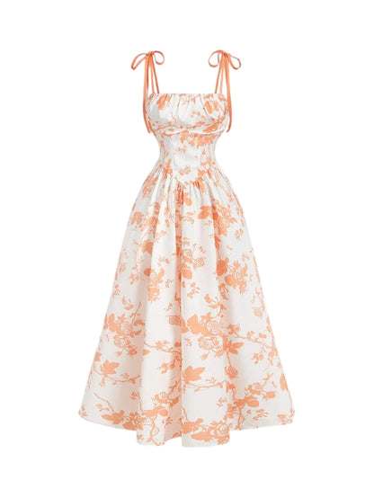 White and orange floral print maxi dress with tie straps and a flowy A-line silhouette