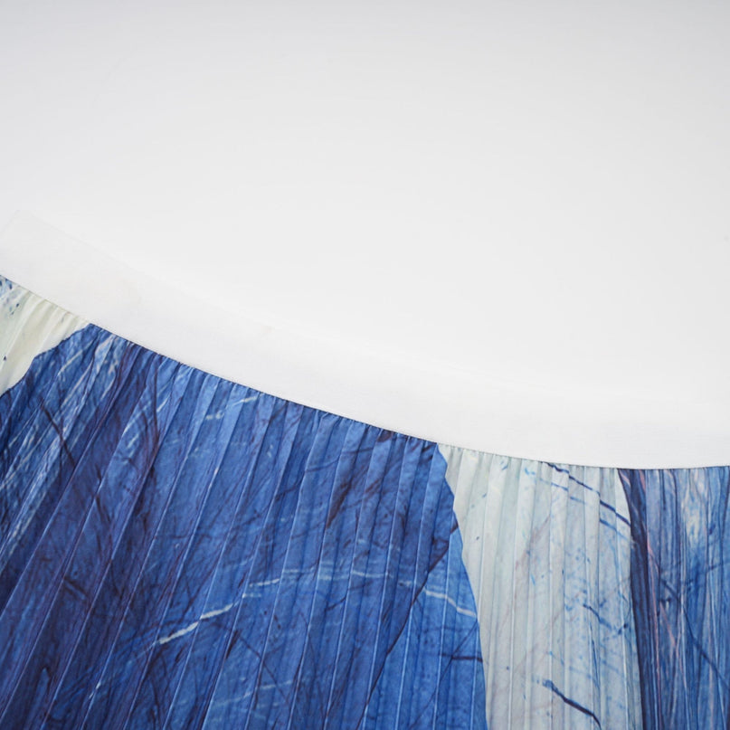 Womens blue floral print outfit featuring a loose creased cape and matching skirt in a coordinated set