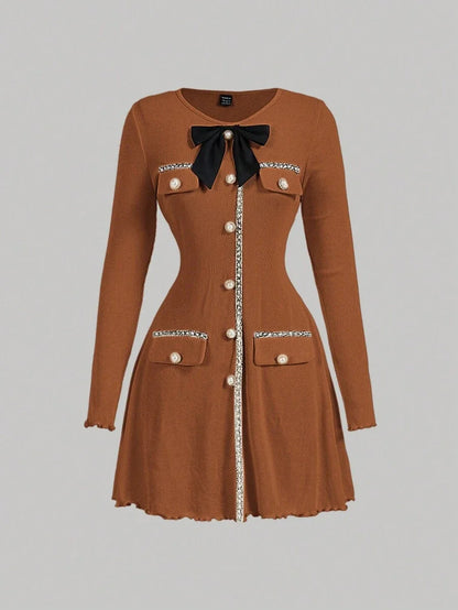 Brown knitted mini dress with pearl buttons, satin bow, and decorative pockets, featuring a tailored fit and ribbed texture for an elegant yet cozy look