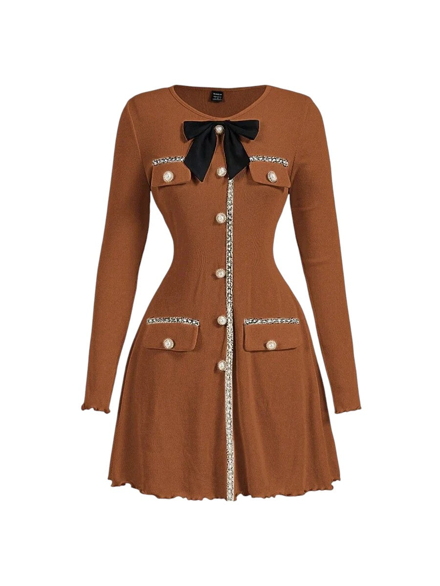 Brown knitted mini dress with pearl buttons, satin bow, and decorative pockets, featuring a tailored fit and ribbed texture for an elegant yet cozy look