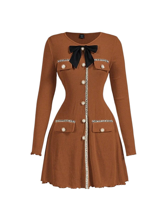 Brown knitted mini dress with pearl buttons, satin bow, and decorative pockets, featuring a tailored fit and ribbed texture for an elegant yet cozy look