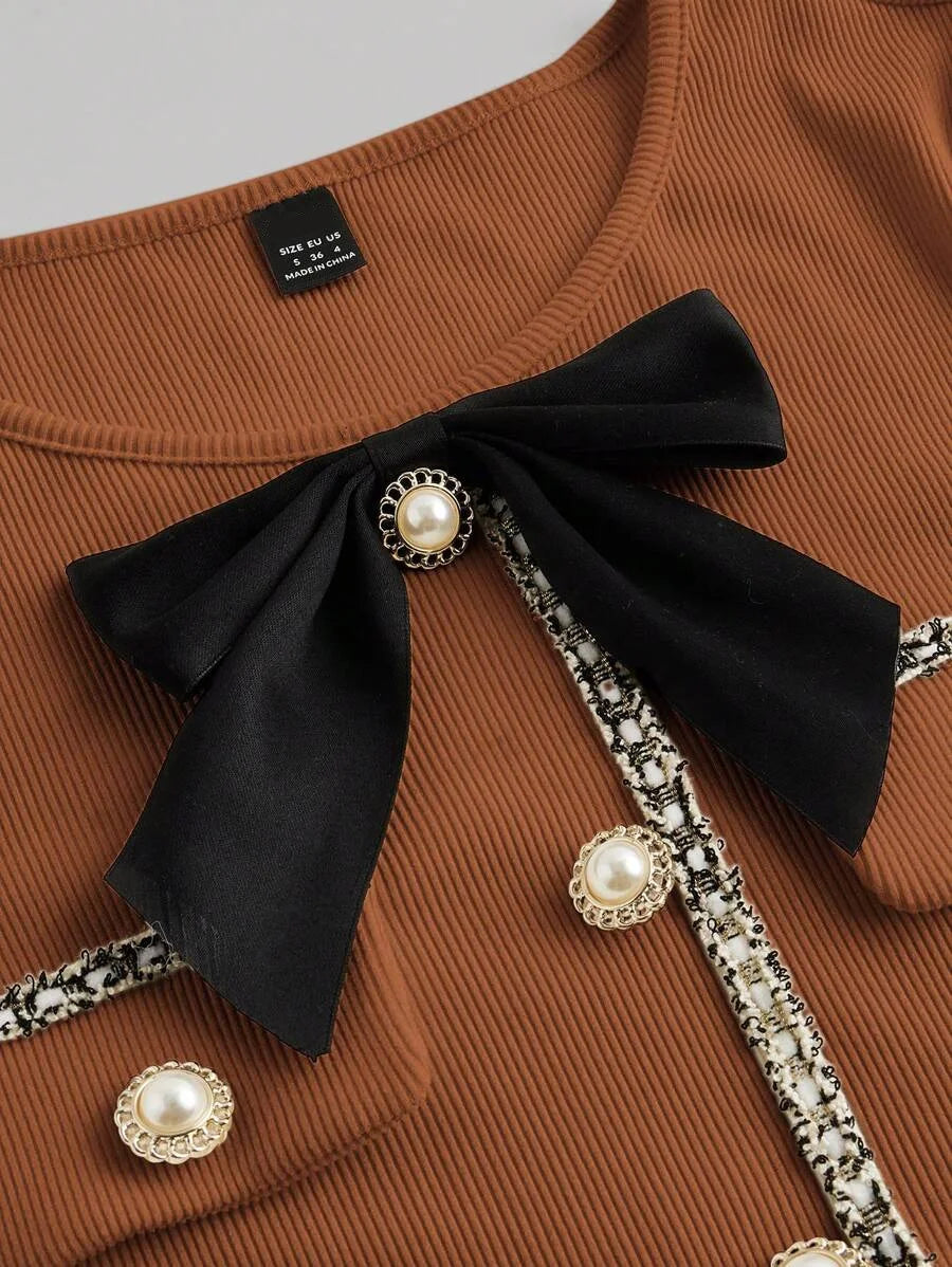 Brown knitted mini dress with pearl buttons, satin bow, and decorative pockets, featuring a tailored fit and ribbed texture for an elegant yet cozy look