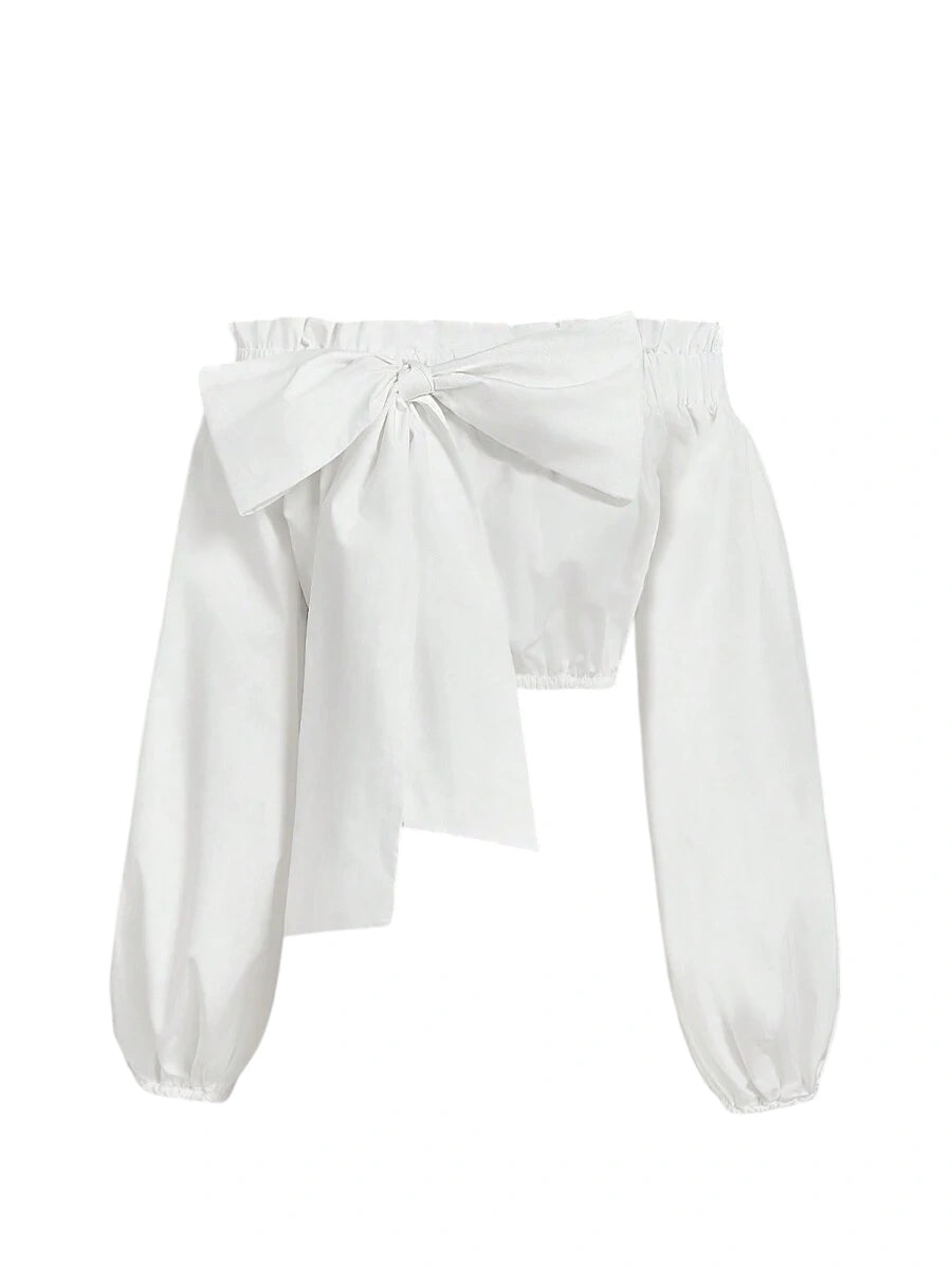 Amelia off-shoulder bow blouse with oversized bow detail, voluminous sleeves, and a cropped fit