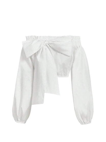 Amelia off-shoulder bow blouse with oversized bow detail, voluminous sleeves, and a cropped fit