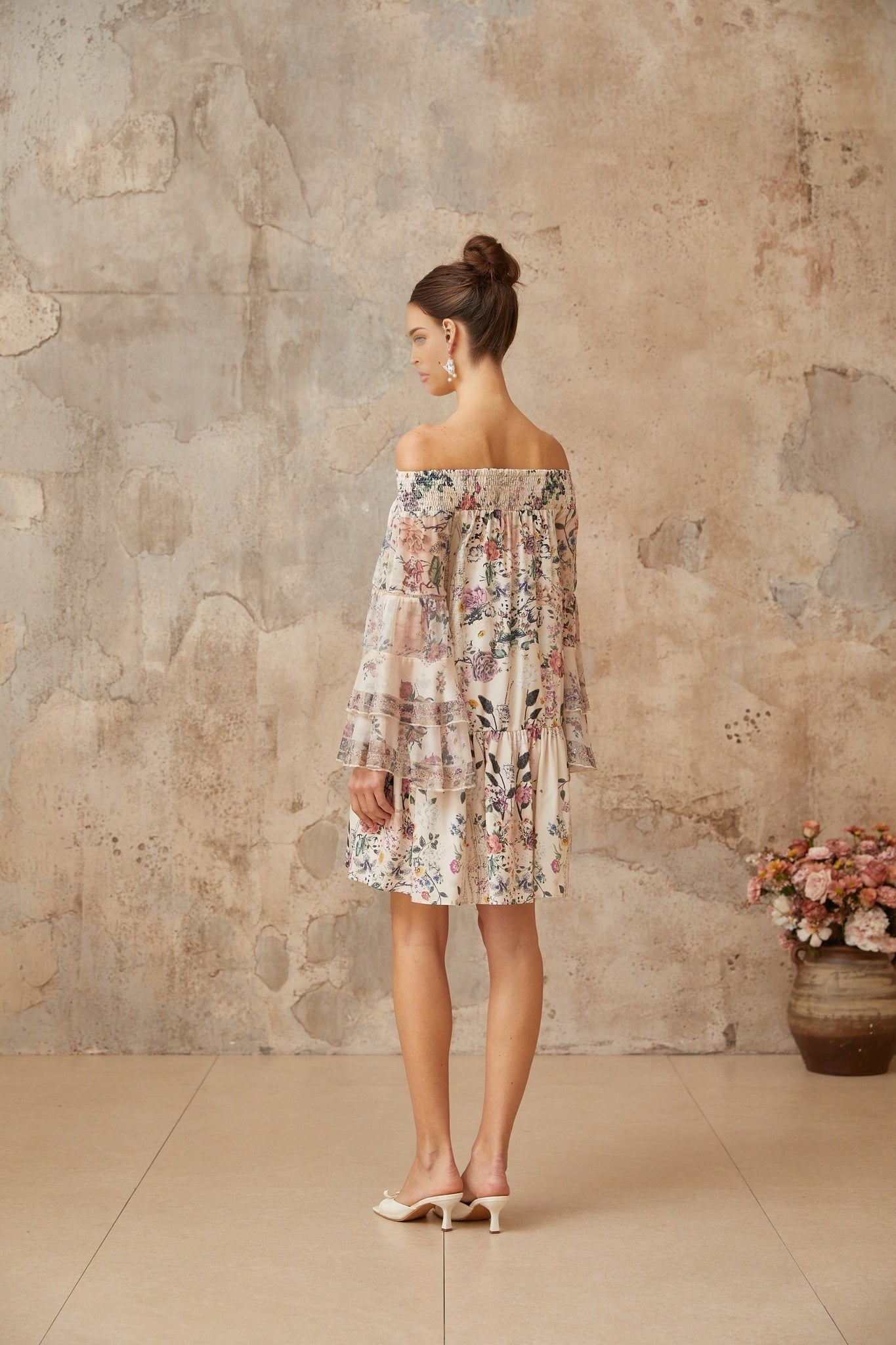 Yasmine mini dress with smocked bodice and floral print pattern on fabric