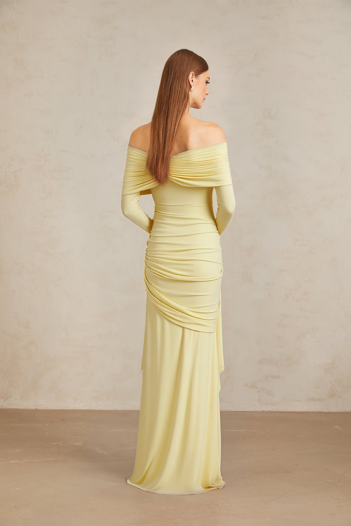 Yellow off the shoulder long sleeve dress with front tie detail and pleated, asymmetrical, ruched, and draped detailing