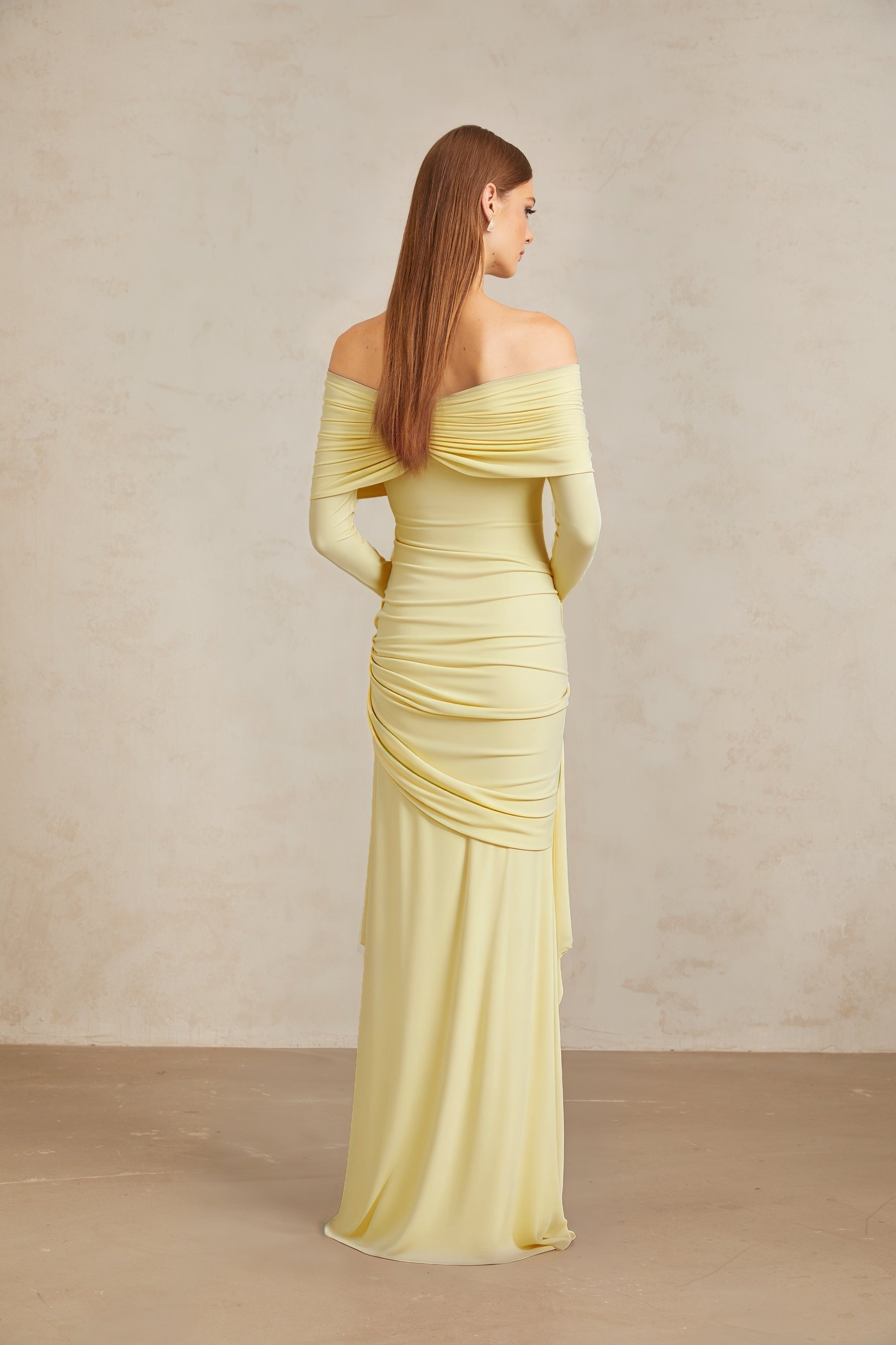 Yellow off the shoulder long sleeve dress with front tie detail and pleated, asymmetrical, ruched, and draped detailing