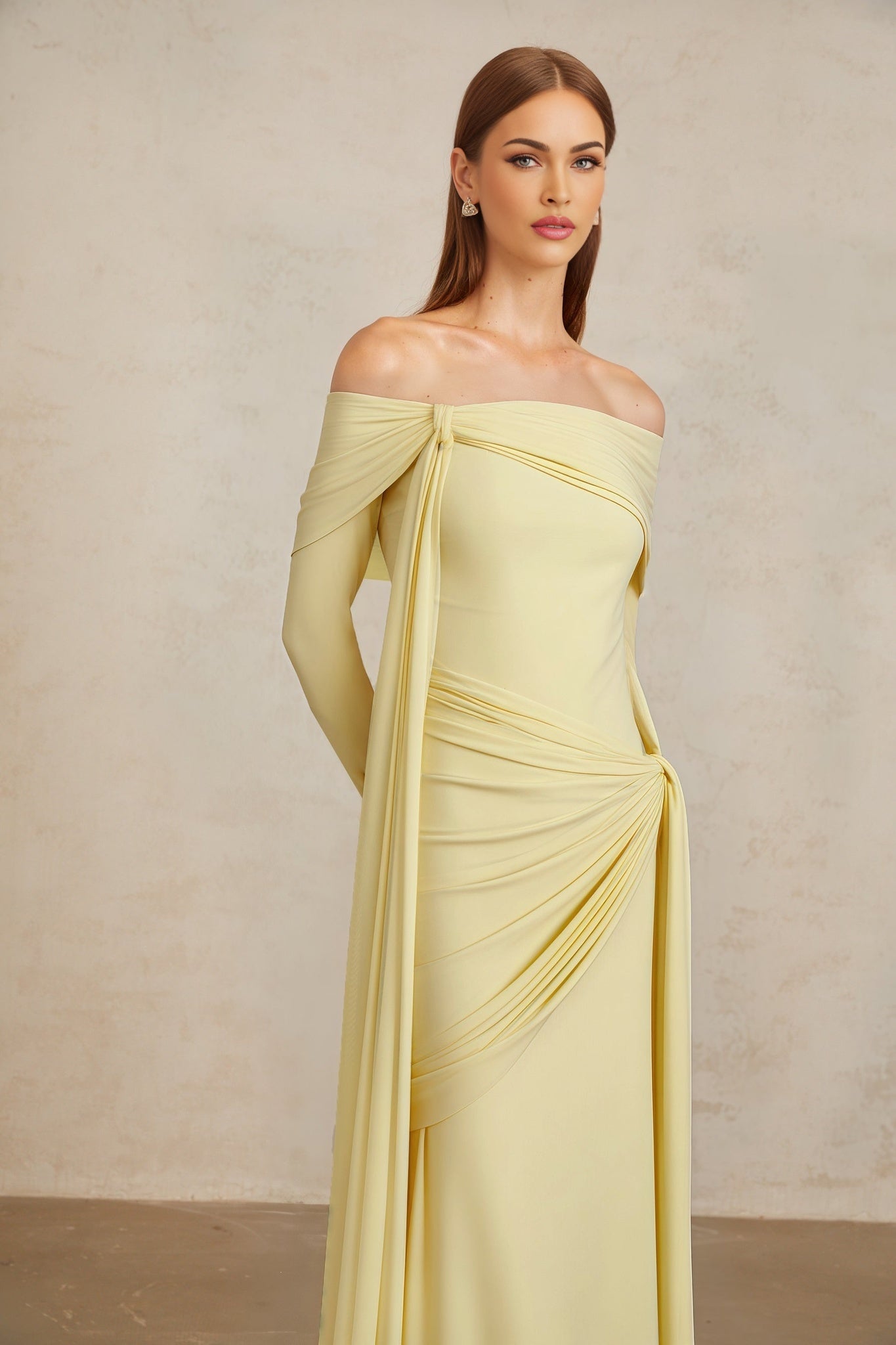 Light yellow off the shoulder long sleeve dress with front tie detail, pleated, asymmetrical, ruched, and draped detailing