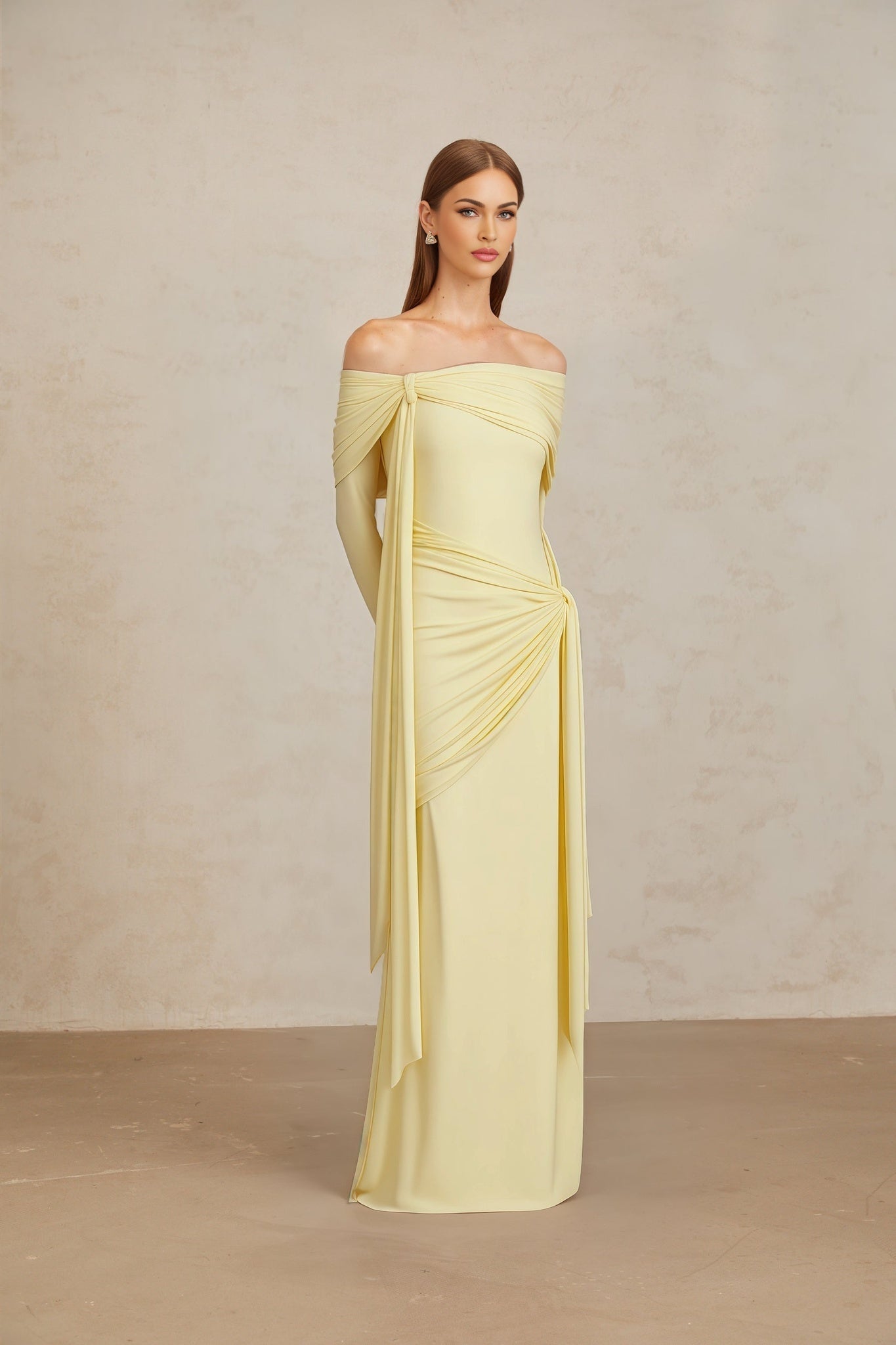 Yellow off the shoulder long sleeve maxi dress with front tie detail and pleated, asymmetrical, ruched, and draped detailing