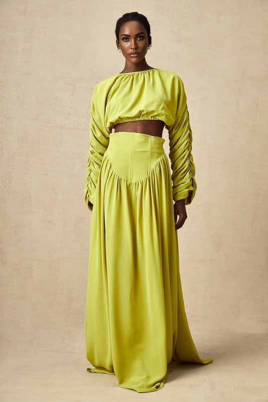 Young girl wearing a green matching set with smocked top and skirt Emilie style