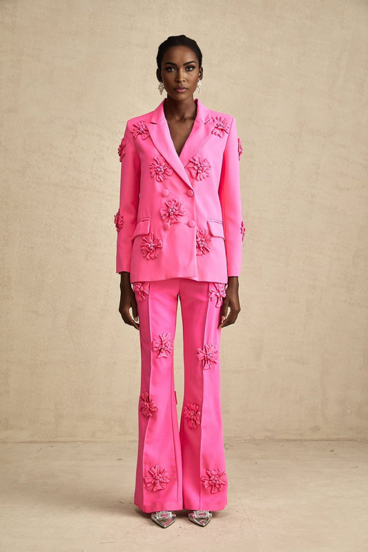 Young girl wearing a pink floral jacket with matching trousers set named AmelieRose
