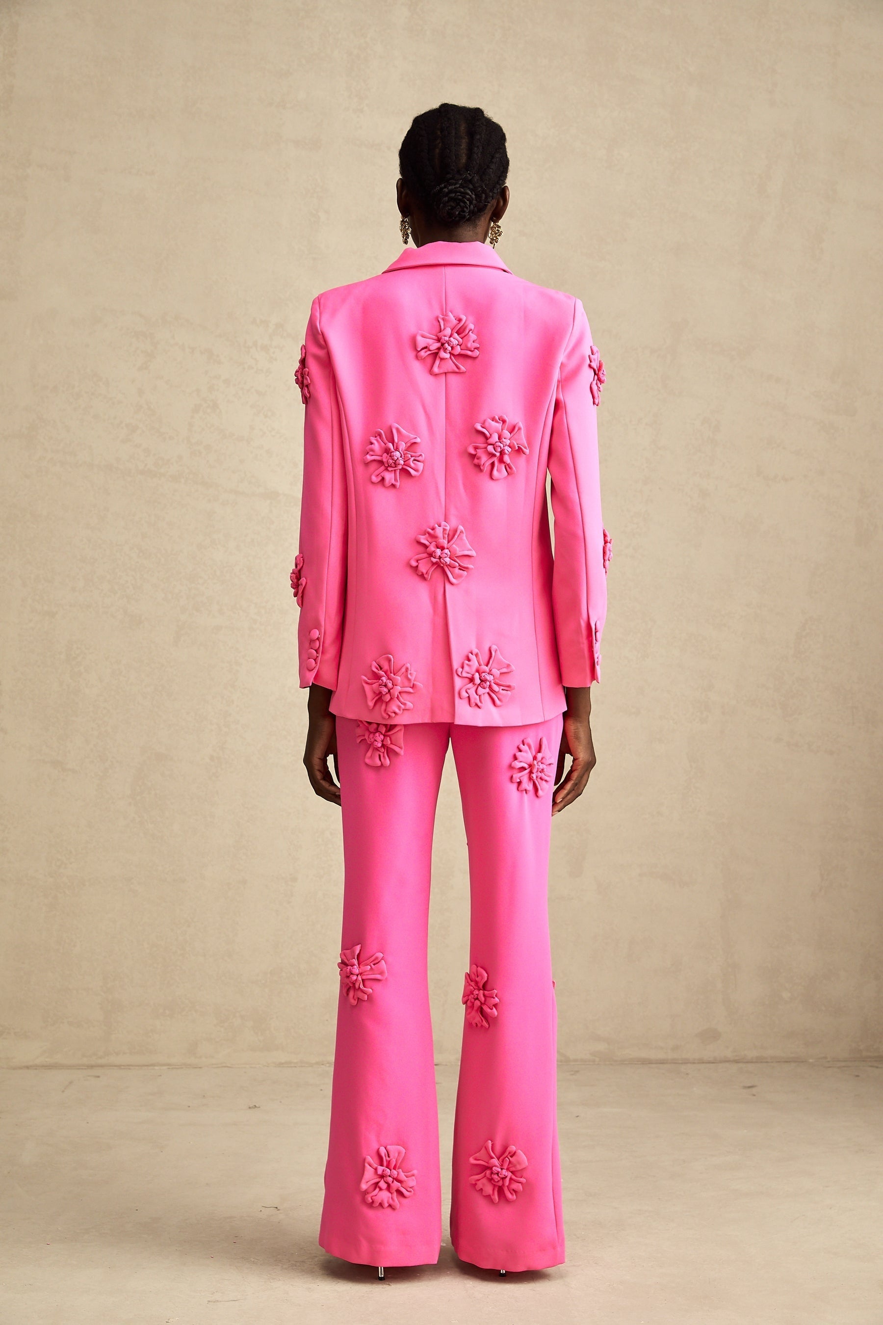 Young girl wearing pink floral jacket and matching trousers set named AmelieRose