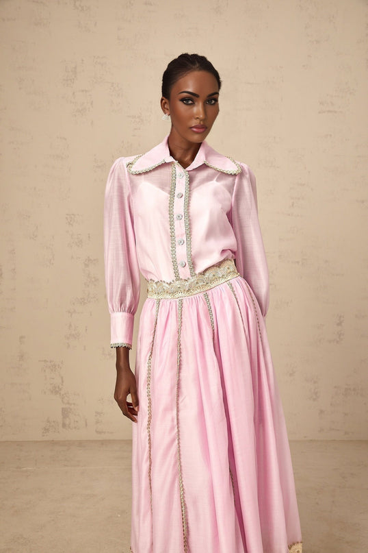 Young girl wearing pink lace trimmed shirt with matching skirt Frida outfit set