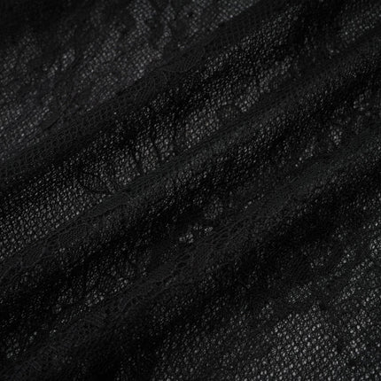 Young woman wearing a black oneshoulder maxi dress with a cutout detail