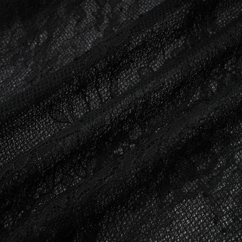 Young woman wearing a black oneshoulder maxi dress with a cutout detail