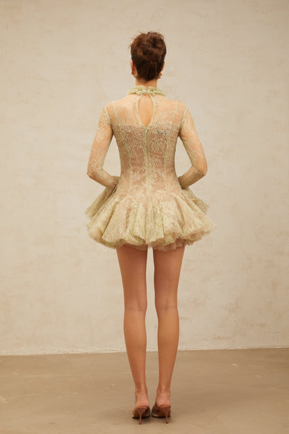 Young woman wearing a green mini dress with floral embroidery and flared skirt design