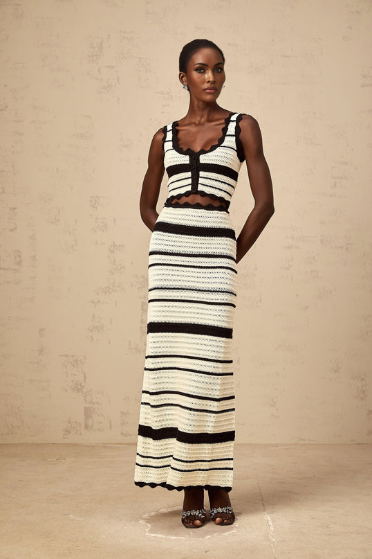 Young woman wearing a matching set consisting of a striped vest top and skirt in contrasting colors named Avril