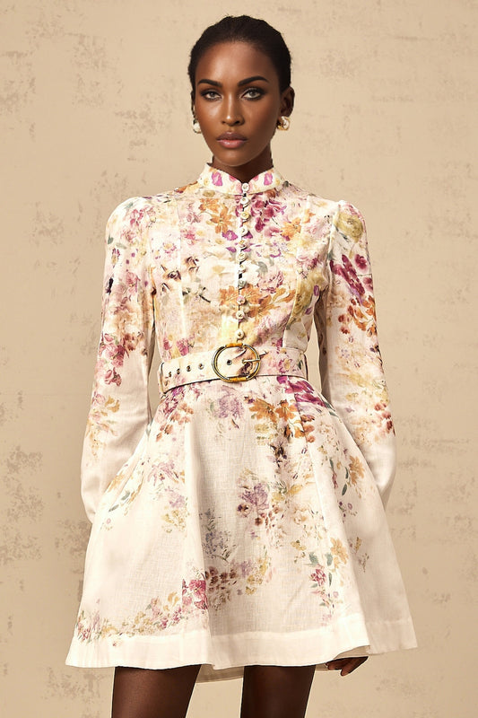 Young woman wearing a short floral print dress with a white background and pink flowers walking on a city street