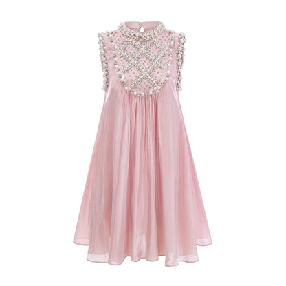 Young woman wearing a short pink dress with pleated skirt and embellished bodice