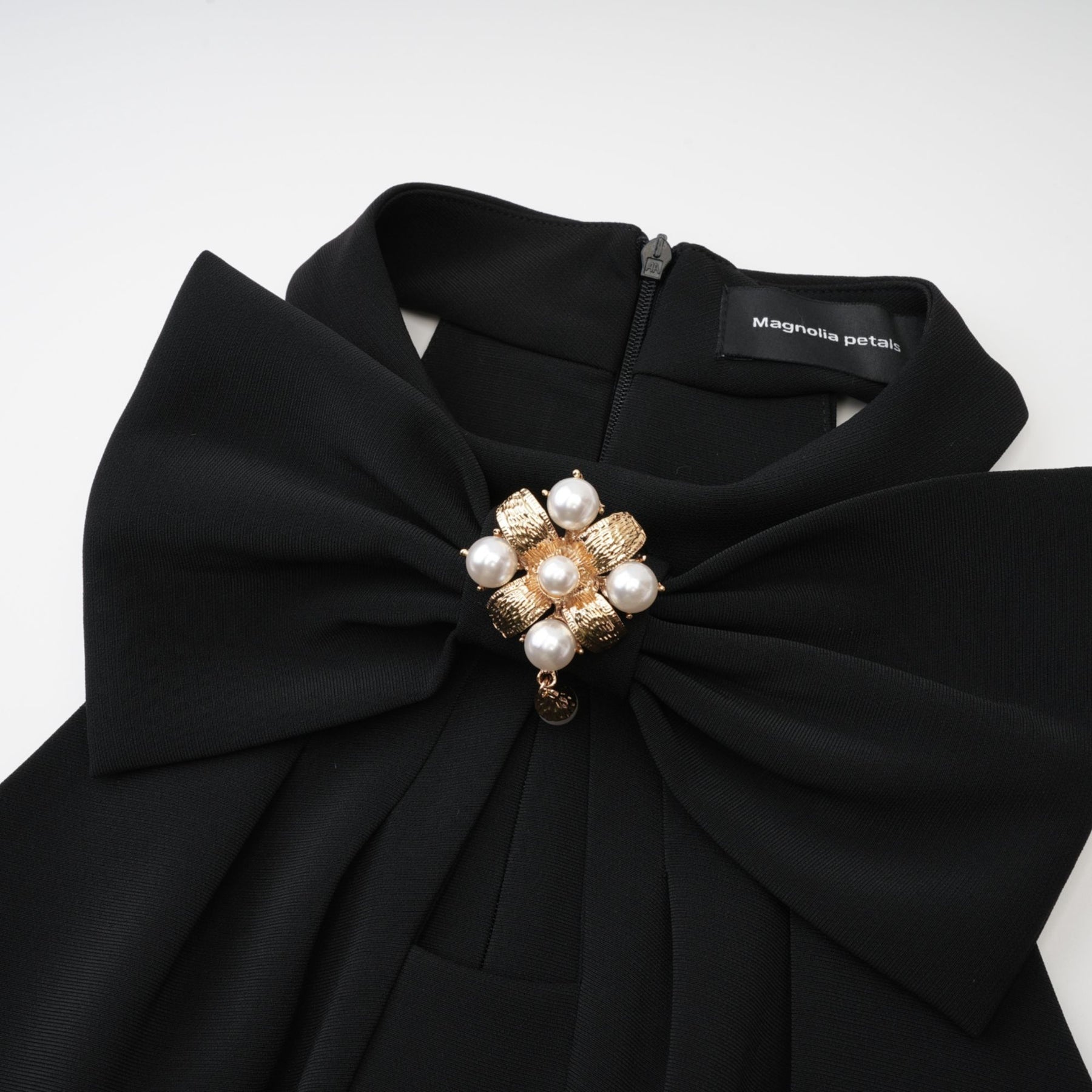 Black sleeveless dress with cutout design featuring bowknot embellishment thigh length straight hem and rear zip fastening Made of 65% viscose 35% polyamide